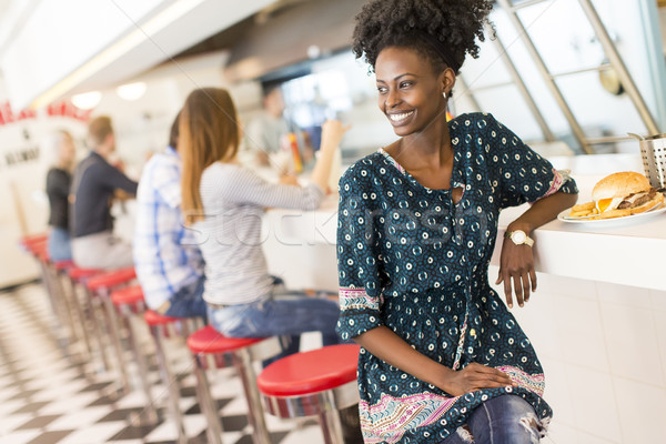 Young black woman in the diner Stock photo © boggy