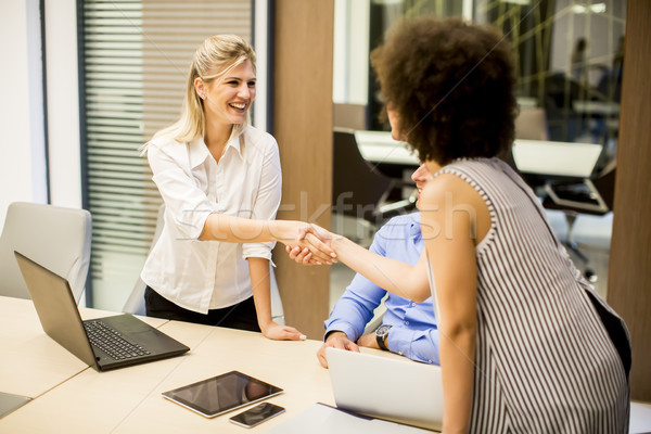 Two young businesswomen shaking hands after a job well done Stock photo © boggy
