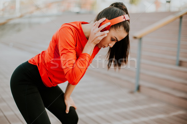 Attractive female runner taking break after jogging outdoors Stock photo © boggy