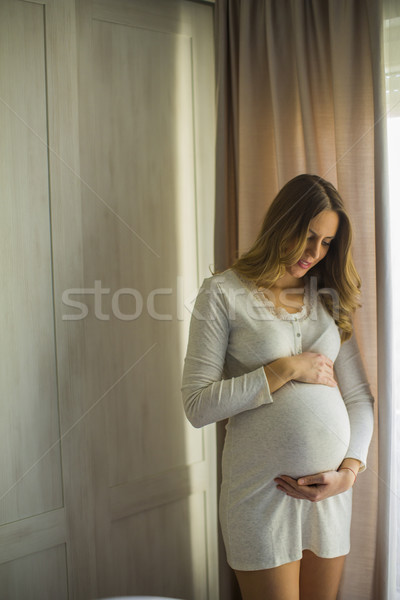 молодые беременная женщина окна портрет женщину счастливым Сток-фото © boggy