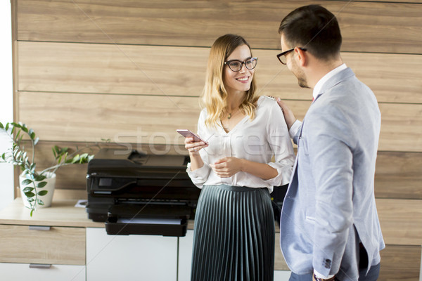 Stock photo: Business people talking in office by the scanner mashine