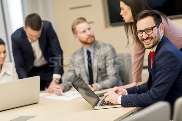 Group of happy young business people in a meeting at office Stock photo © boggy