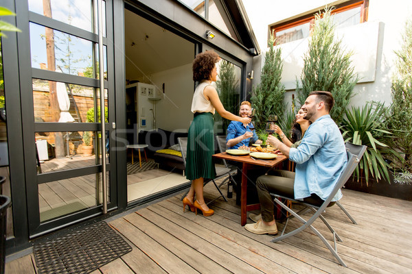 Cheerful young people have lunch in the courtyard and a fun Stock photo © boggy