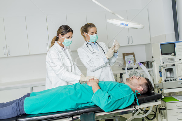 Female doctors preparing patient for intervention Stock photo © boggy