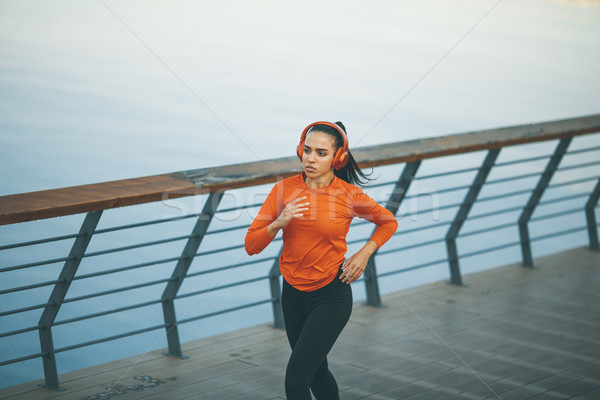 Stock photo: Active young beautiful woman running in urban enviroment