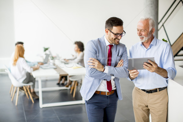 Businessmen with digital tablet in office Stock photo © boggy