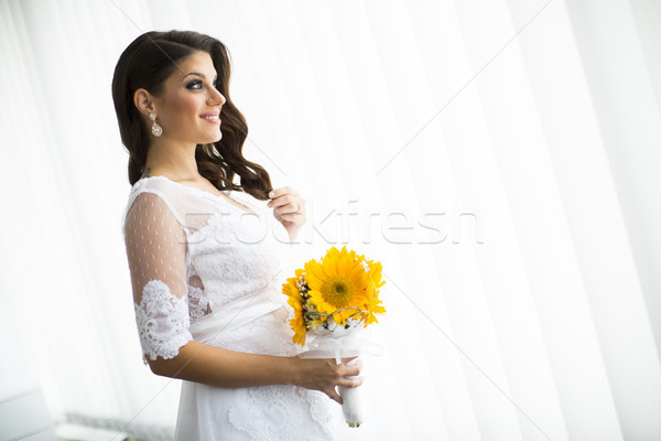 Stock photo: Pregnant bride with a bouquet of sunflowers