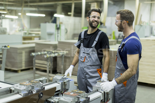 Young male workers work in a factory for the production of furni Stock photo © boggy