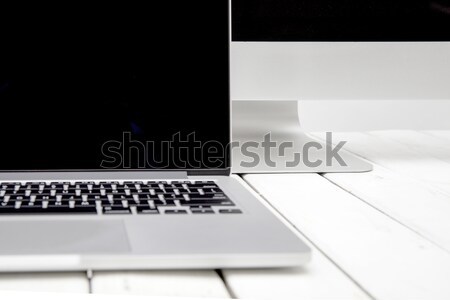 Laptop with black screen on white wooden table by white backgrou Stock photo © boggy