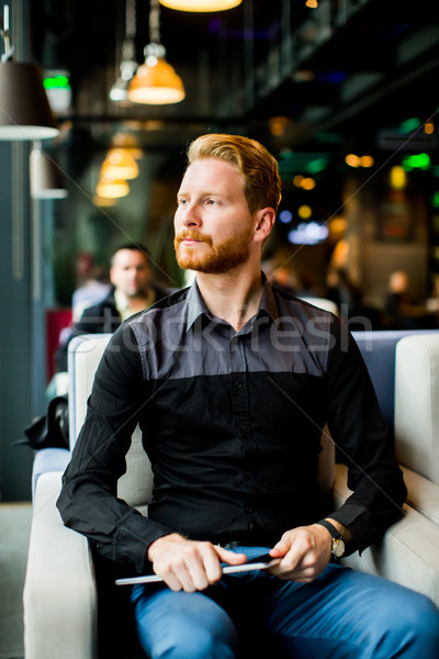 Young man with tablet Stock photo © boggy