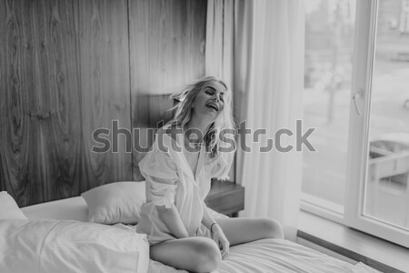Fiatal szőke nő ül ágy szoba külső Stock fotó © boggy