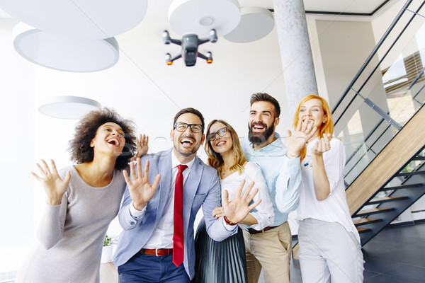 Stock photo: Young business people  letting the drone camera to fly over the 