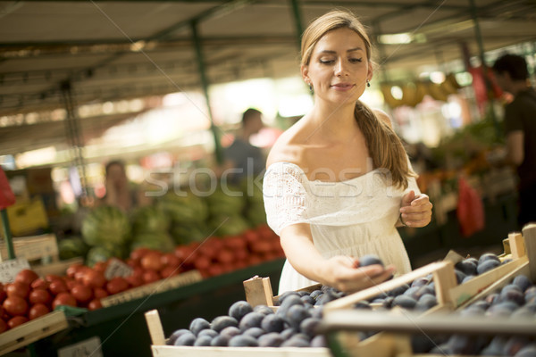 Young woman buying fruits on the market Stock photo © boggy