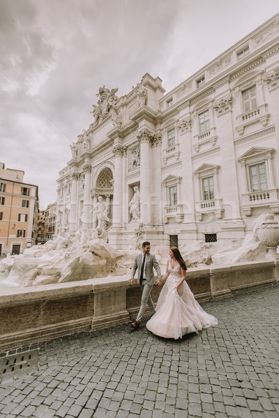 Bride and groom posing in front of Trevi Fountain (Fontana di Tr Stock photo © boggy