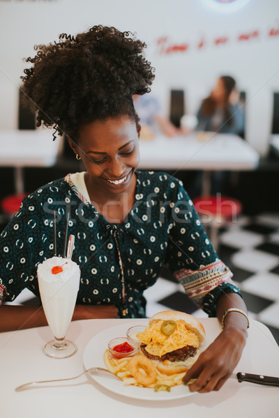 молодые афроамериканец женщину еды Diner портрет Сток-фото © boggy