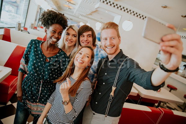 Group of young people taking selfie with mobile phone Stock photo © boggy