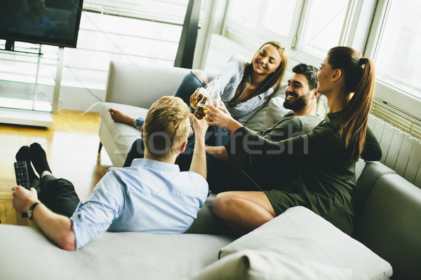 Group of young friends drinking cider and having fun Stock photo © boggy