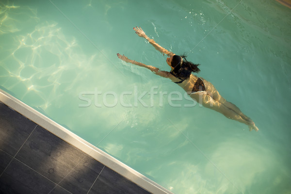 Woman in bikini  floating on water in the pool Stock photo © boggy