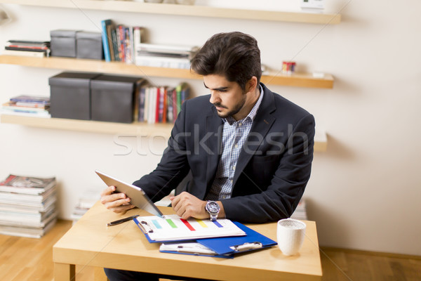 Businessman analyzing investment charts on digital tablet Stock photo © boggy