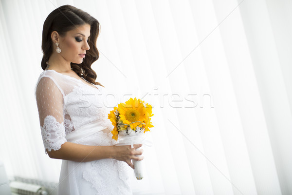 Stock photo: Pregnant bride with a bouquet of sunflowers