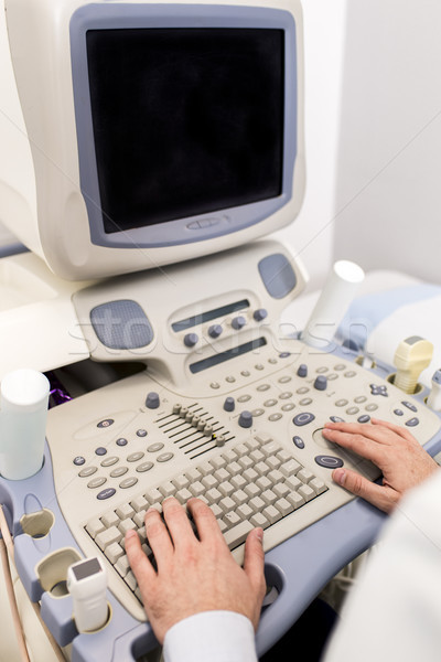 Doctor working on ultrasounds keyboard Stock photo © boggy