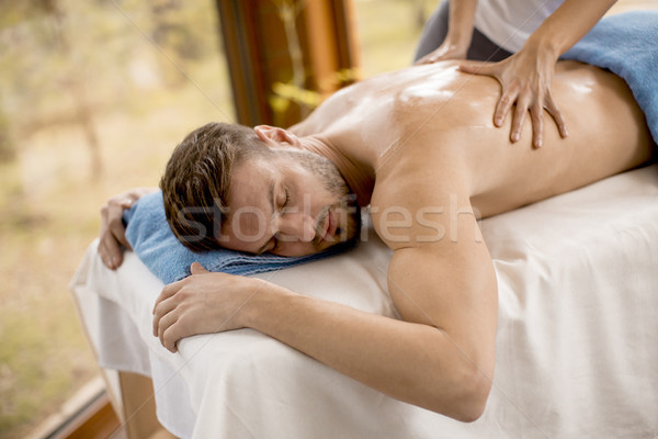 Young man having massage in the spa Stock photo © boggy