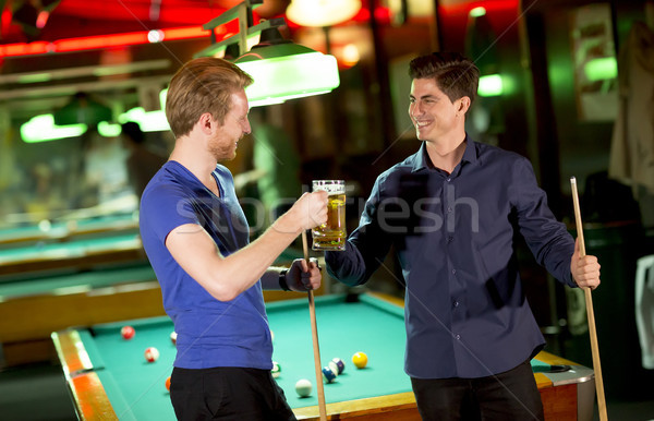 Two young man toasting with a beer Stock photo © boggy