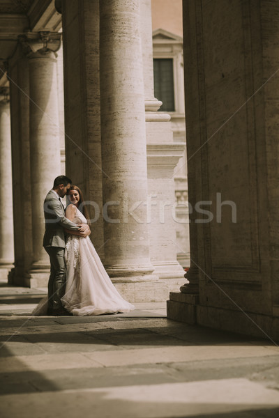 Young newly married couple  posing in Rome with beautiful and an Stock photo © boggy