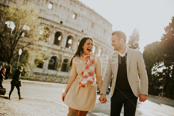 Loving couple visiting Italian famous landmarks Colosseum in Rom Stock photo © boggy