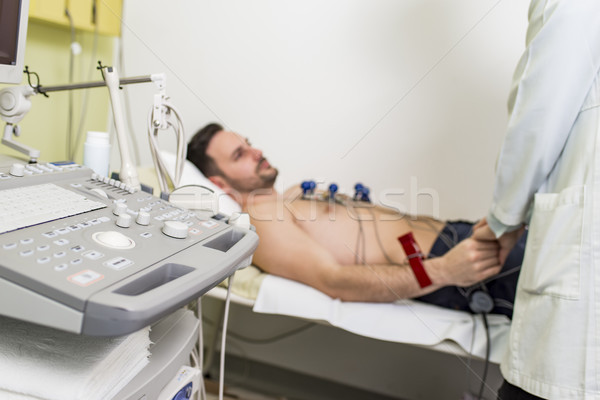 Young man doing EKG in hospital Stock photo © boggy