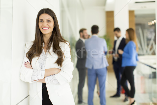 Stock photo: Businesswoman standing with her arms crossed