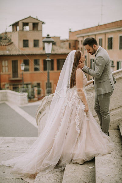 Bride and groom walking outdoors at Spagna Square and Trinita' d Stock photo © boggy