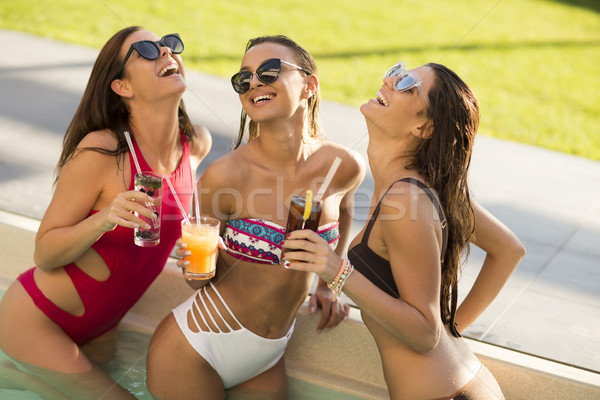 Young woman drinking coctail and having fun by the pool Stock photo © boggy