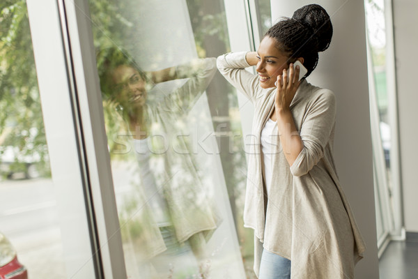 Joli jeune femme parler téléphone femme bureau [[stock_photo]] © boggy