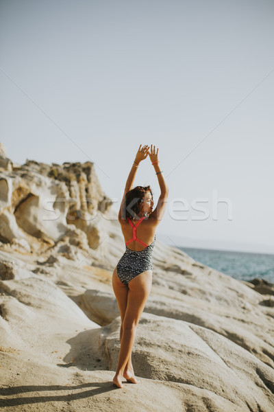 Pretty young woman on the stony beach Stock photo © boggy