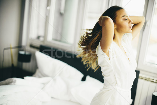 Young woman in the room gets out of bed Stock photo © boggy