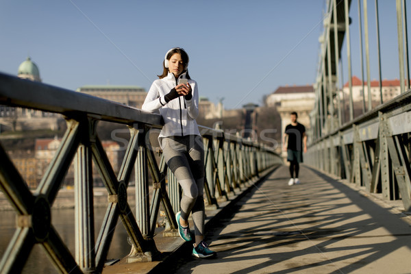 Woman on the bridge making a pause after the exercise Stock photo © boggy