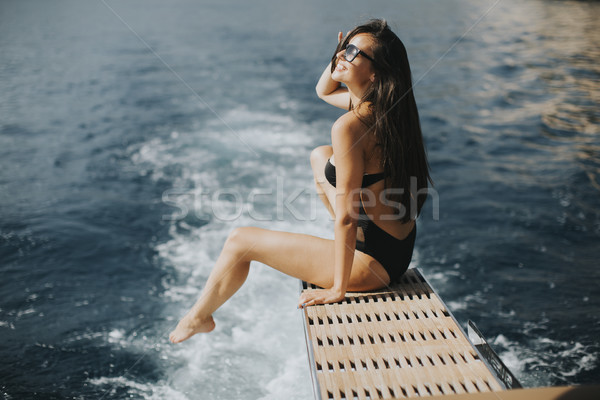 Pretty woman relaxing on the yacht on sea at sunny day Stock photo © boggy