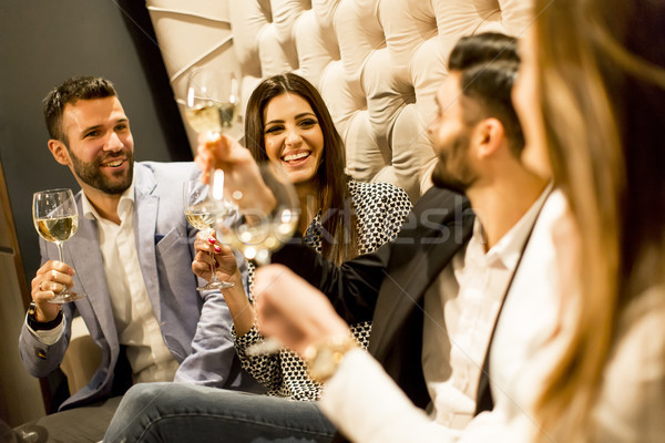 Group of young people celebrating and toasting with white wine Stock photo © boggy