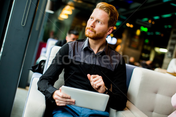 Young man with tablet Stock photo © boggy