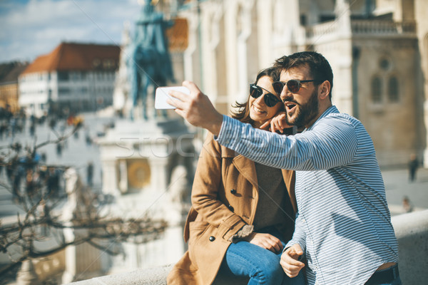 Portrait of loving couple taking selfie Stock photo © boggy