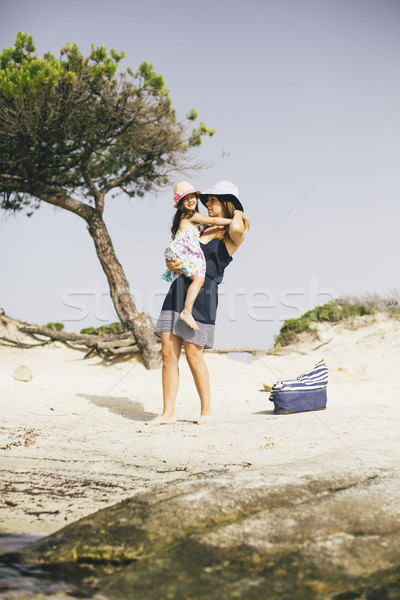 Little girl and her mother have a good time at the seaside Stock photo © boggy