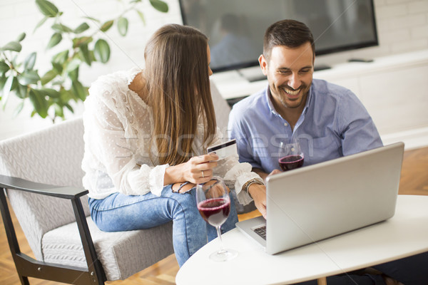 Cheerful couple searching internet and  shopping online Stock photo © boggy