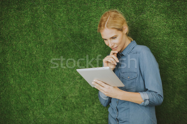 Pretty young woman with tablet Stock photo © boggy