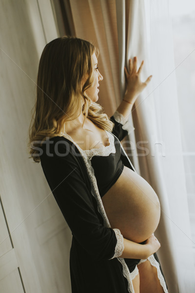 Mulher grávida lingerie posando quarto foto Foto stock © boggy
