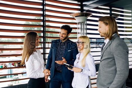 Hugged young business people Stock photo © boggy