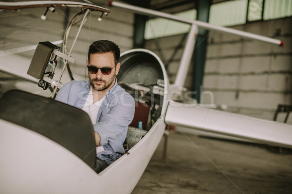 Young pilot checking ultralight airplane before flight Stock photo © boggy