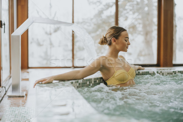 Pretty young woman relaxing in the bubble bath pool Stock photo © boggy