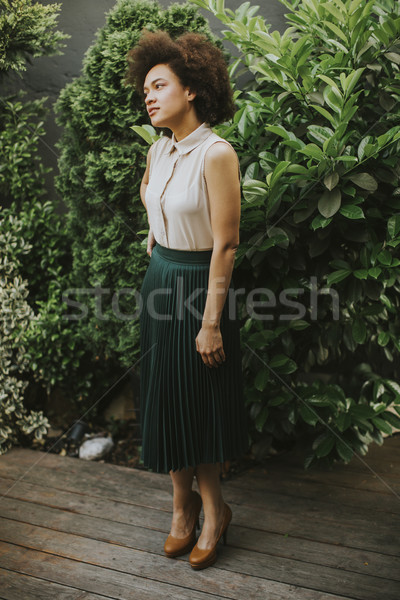 Stock photo: Pretty young african descent woman in the yard