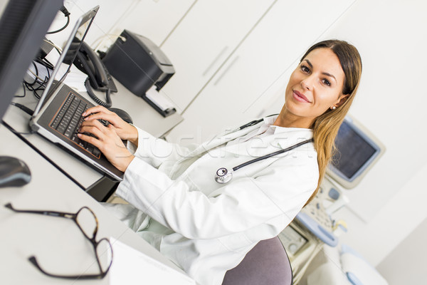 Young female doctor working on computer Stock photo © boggy